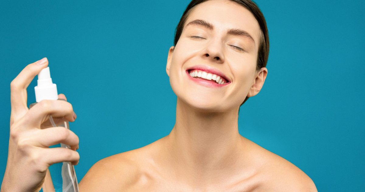 woman spraying on her face